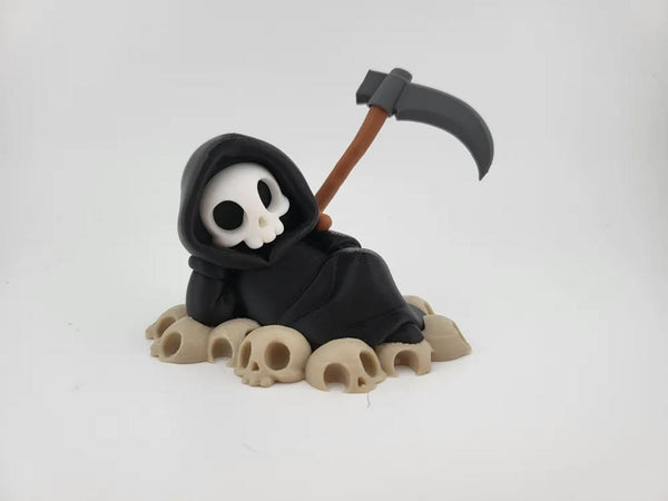 Chillin' Grim Reaper Skeleton Figure on Skull Pile