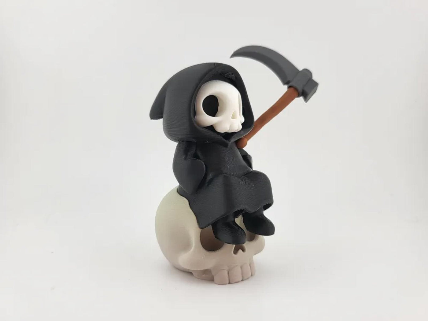 Kawaii Grim Reaper on Skull - Cute Spooky Desktop Decor