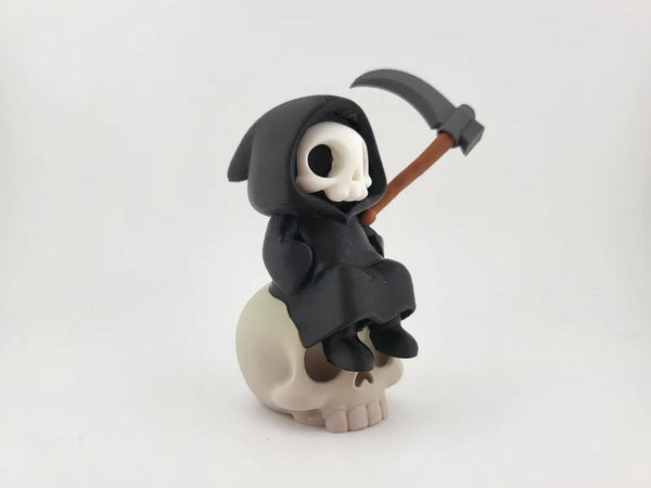 Kawaii Grim Reaper on Skull - Cute Spooky Desktop Decor
